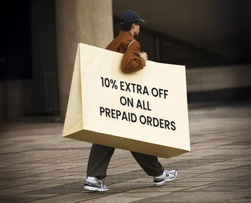 Person carrying a large wall art sign offering a discount on prepaid orders.