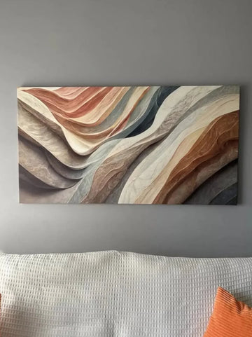 Abstract wall art with wavy patterns in earthy tones on a gray wall.