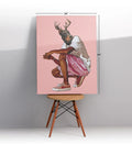 Canvas print of a dog with deer antlers on a pink background.