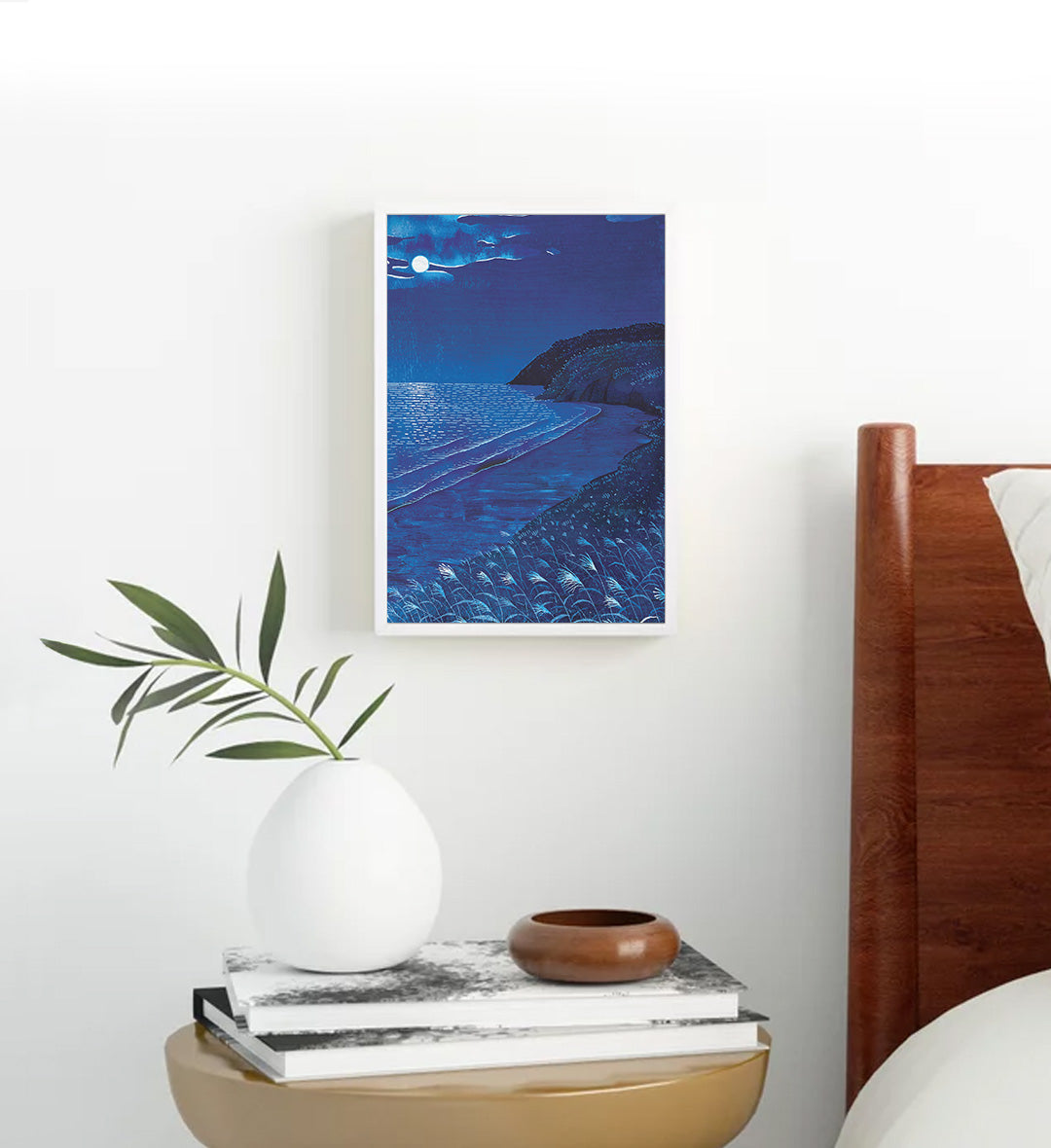 Minimalist living room styled with serene moonlit coast canvas print.