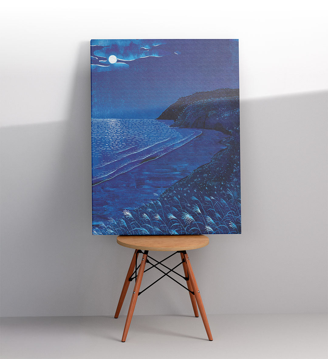 Modern bathroom wall art with blue ocean scenery.