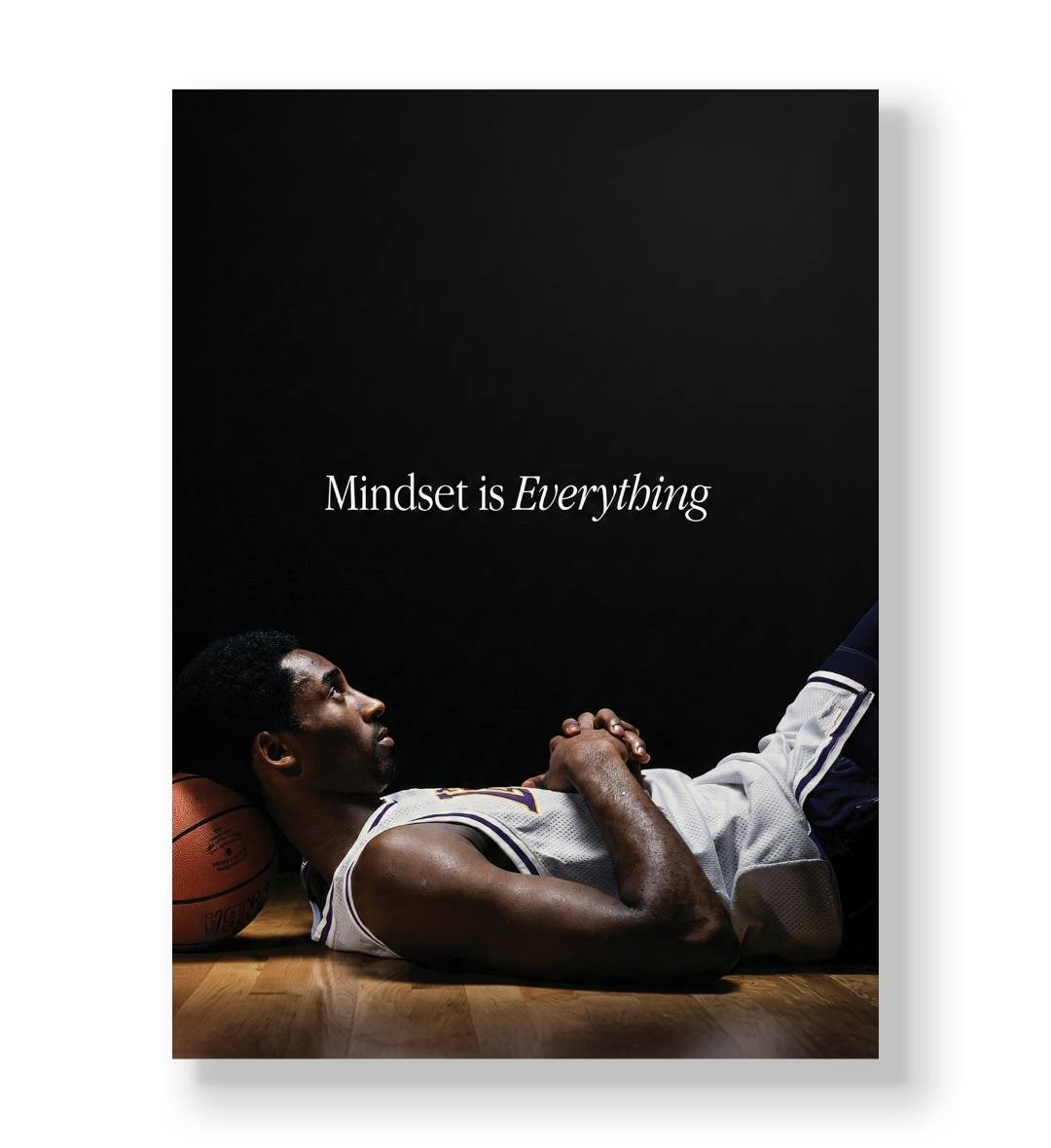 Kobe Bryant lying on the floor resting his head on a basketball with "Mindset is Everything" text canvas wall art.