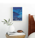 Minimalist living room styled with serene moonlit ocean canvas print.