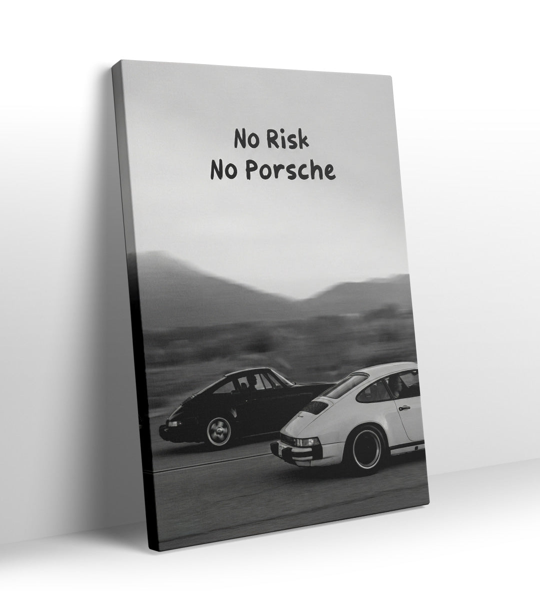 Black and white photo of two Porsche 911s driving fast with "No Risk No Porsche" text canvas wall art.