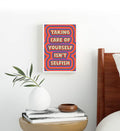 Boho living room decor styled with psychedelic typography canvas print.