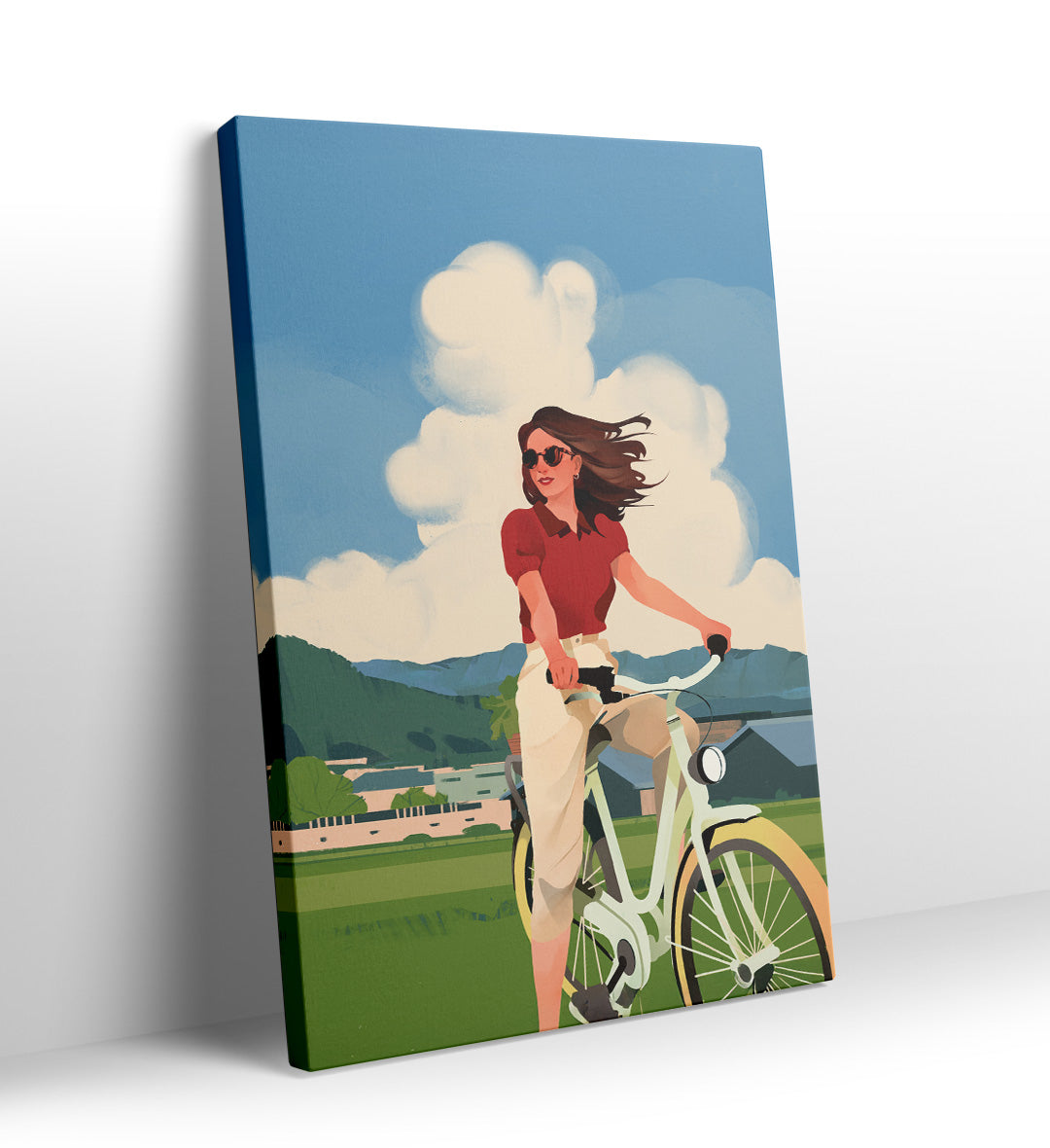 Woman riding a bicycle in a green field with fluffy clouds canvas wall art.