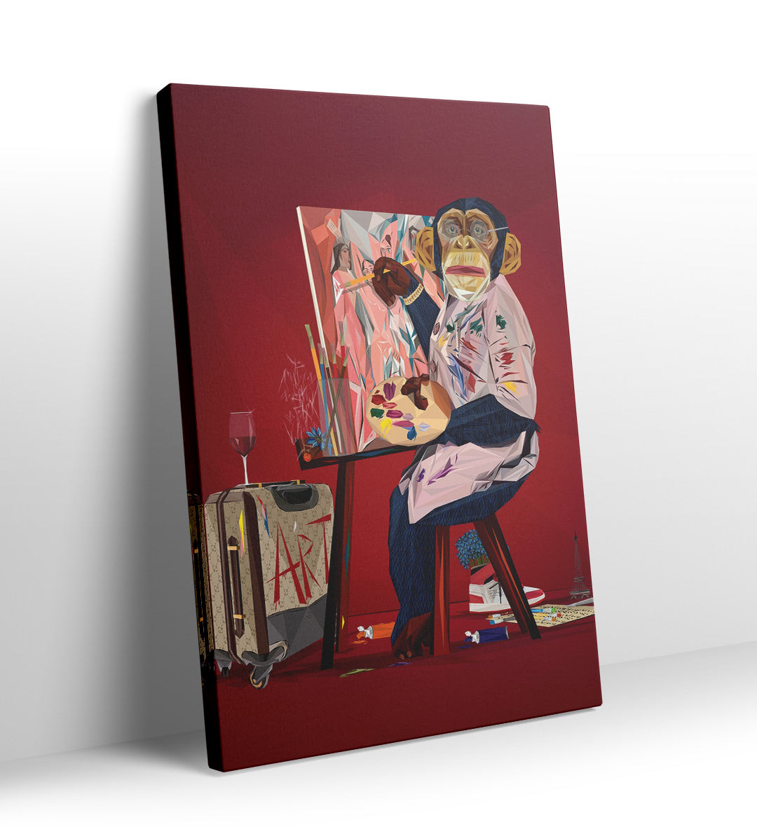 Geometric chimpanzee artist painting on canvas with red background and art supplies.