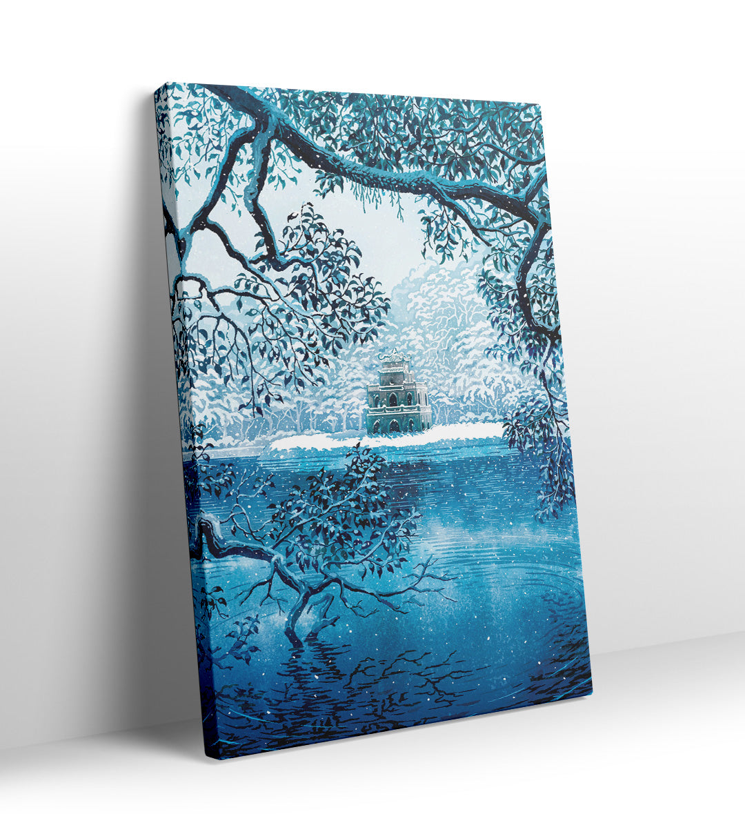 Pagoda on an island in a frozen blue lake framed by snowy branches canvas wall art.